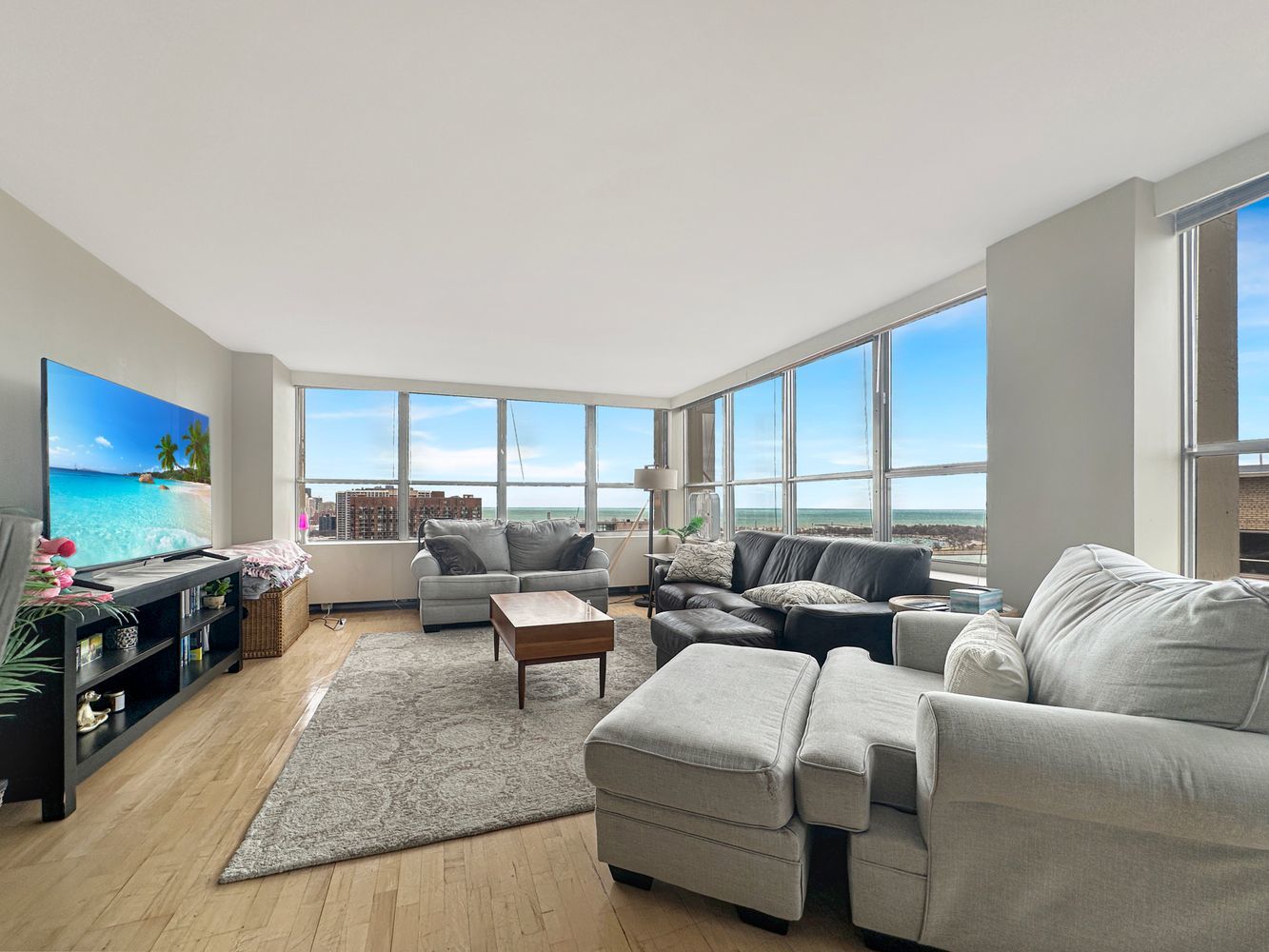 655 West Irving Park Road, Unit 2302 Chicago, IL 60613 - Photo 3 of 41 a living room with furniture and a flat screen tv