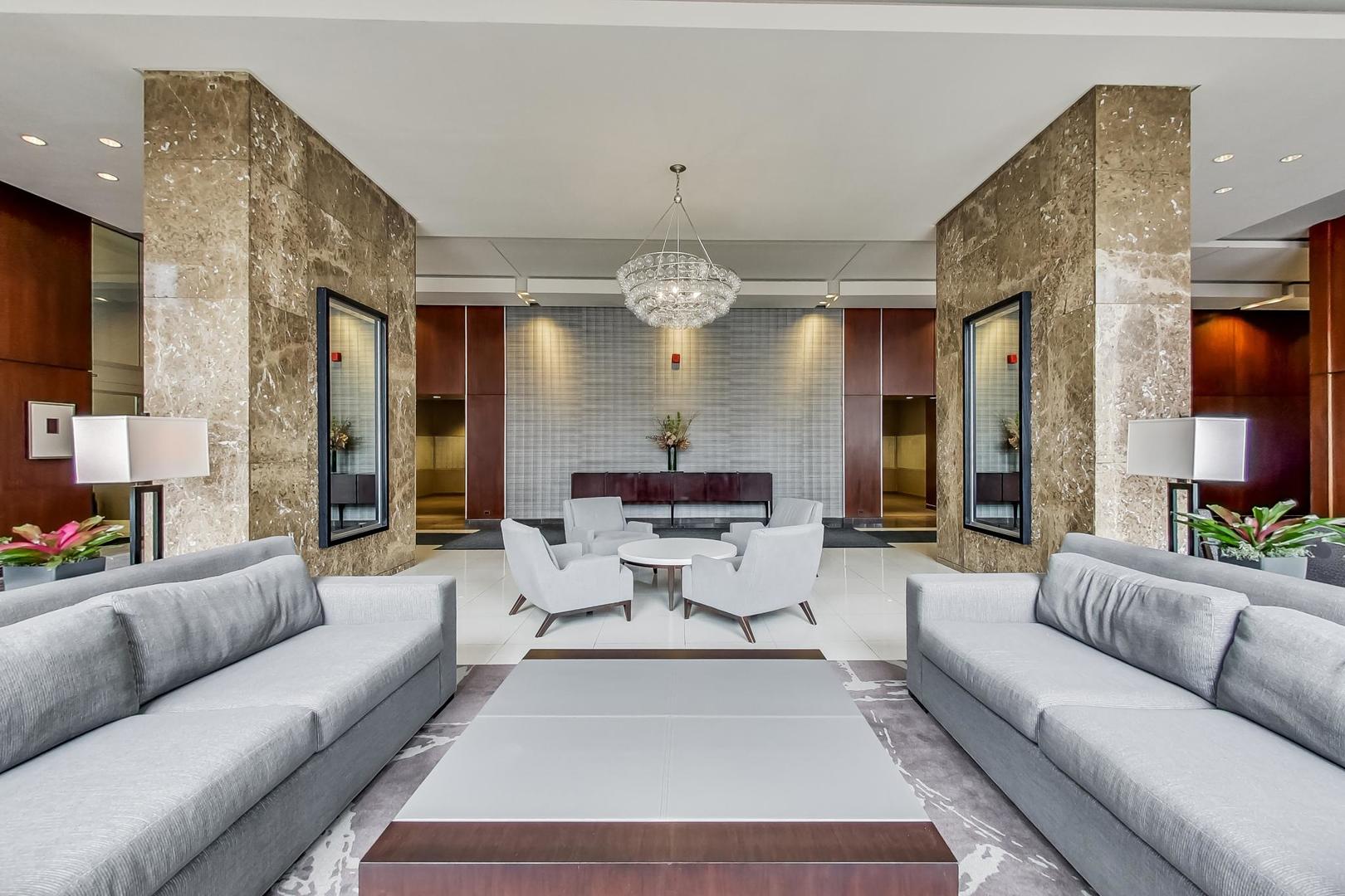 655 West Irving Park Road, Unit 2302 Chicago, IL 60613 - Photo 37 of 41 a living room with furniture and a chandelier