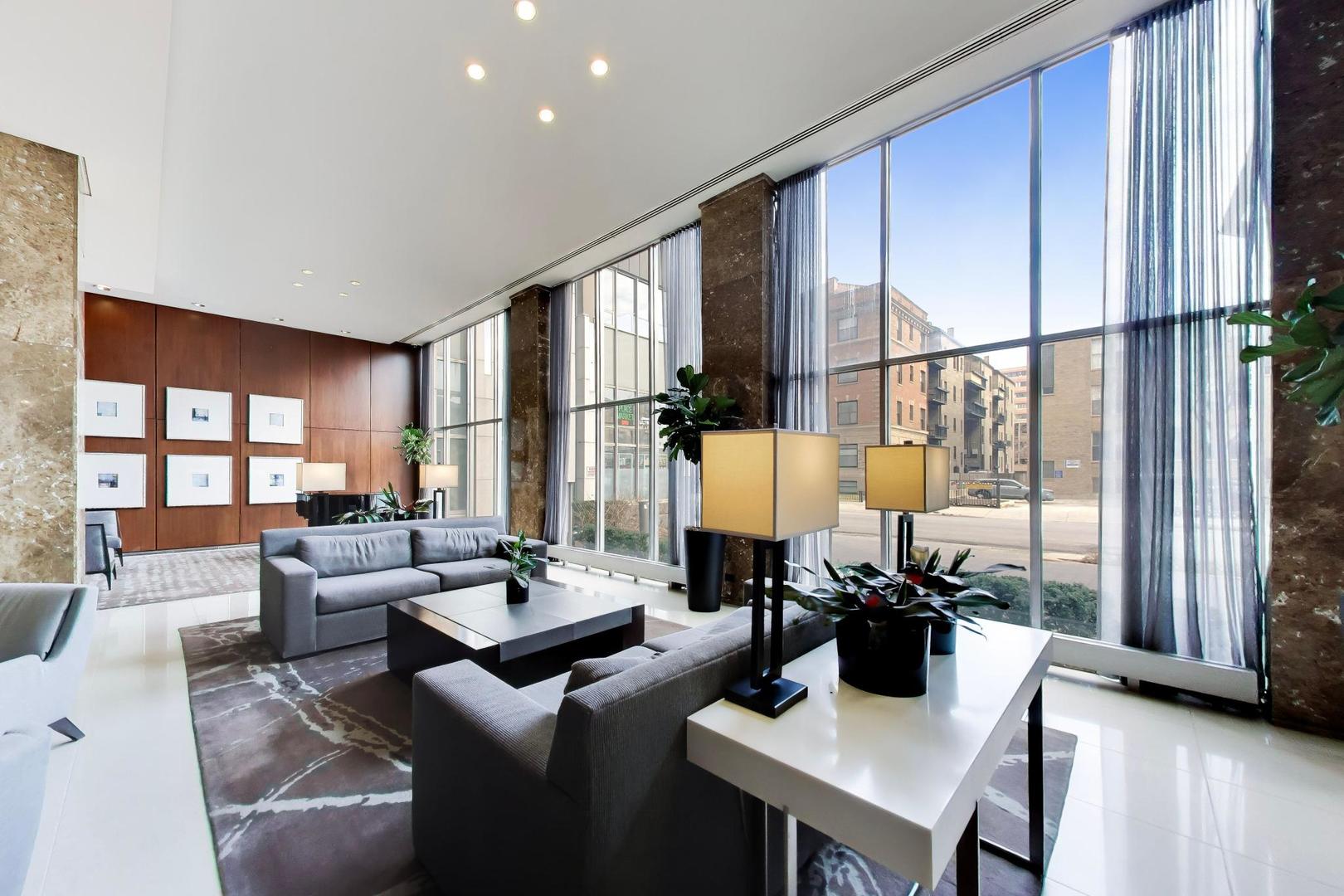 655 West Irving Park Road, Unit 2302 Chicago, IL 60613 - Photo 39 of 41 a living room with furniture and a large window