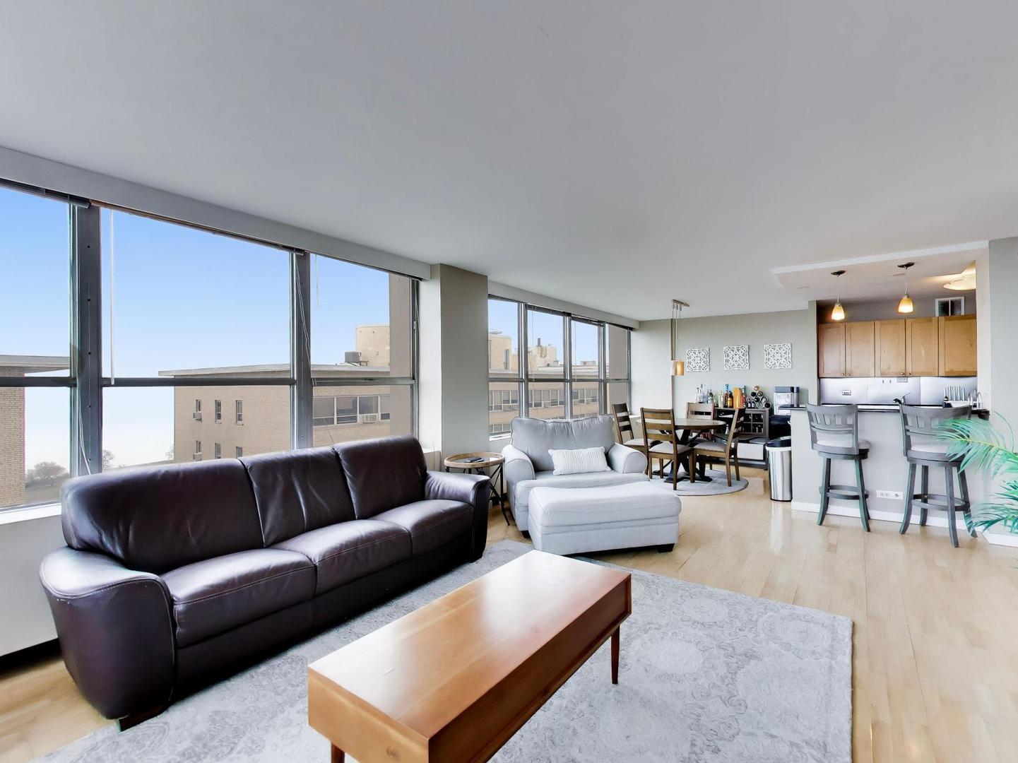 655 West Irving Park Road, Unit 2302 Chicago, IL 60613 - Photo 8 of 41 a living room with furniture and a large window