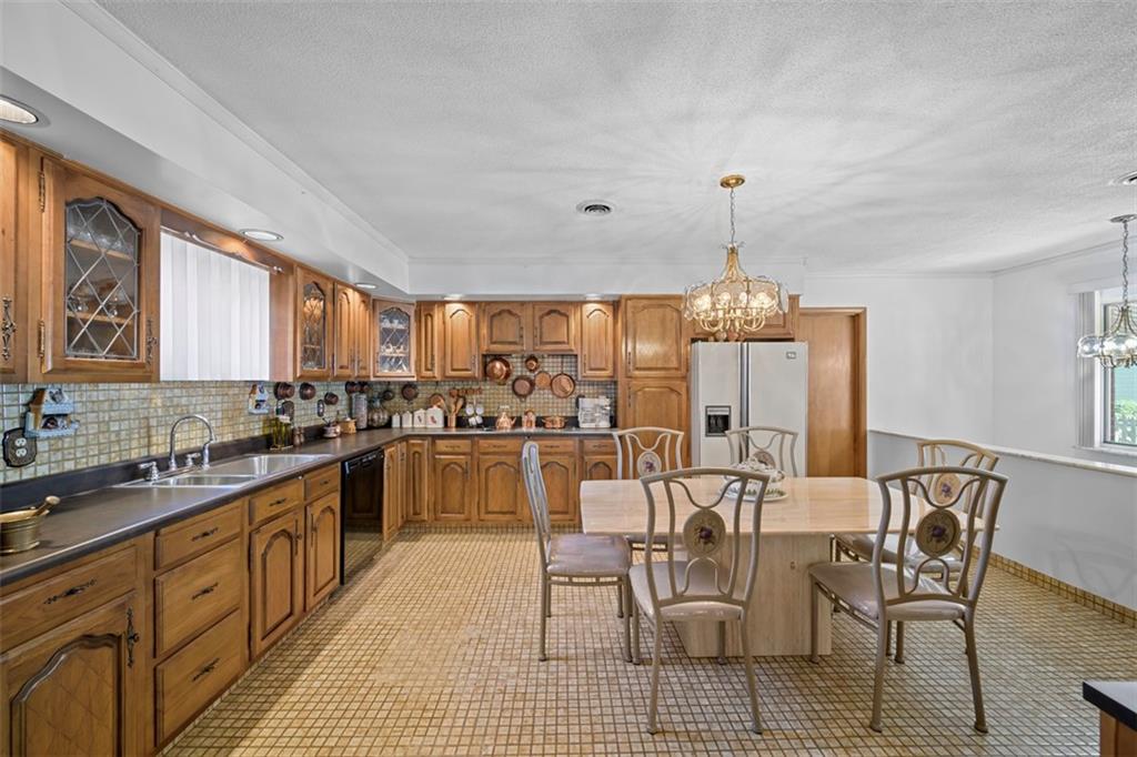 213 18th Street Pittsburgh, PA 15215 - Photo 14 of 42 a large kitchen with a table and chairs