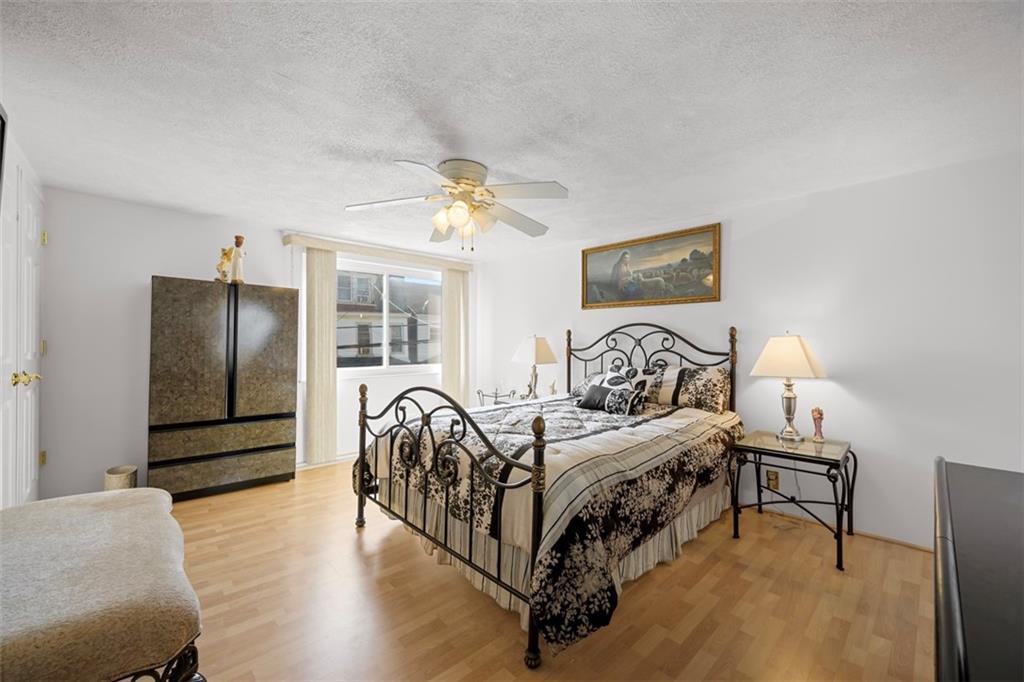 213 18th Street Pittsburgh, PA 15215 - Photo 19 of 42 a bedroom with a bed and a chandelier