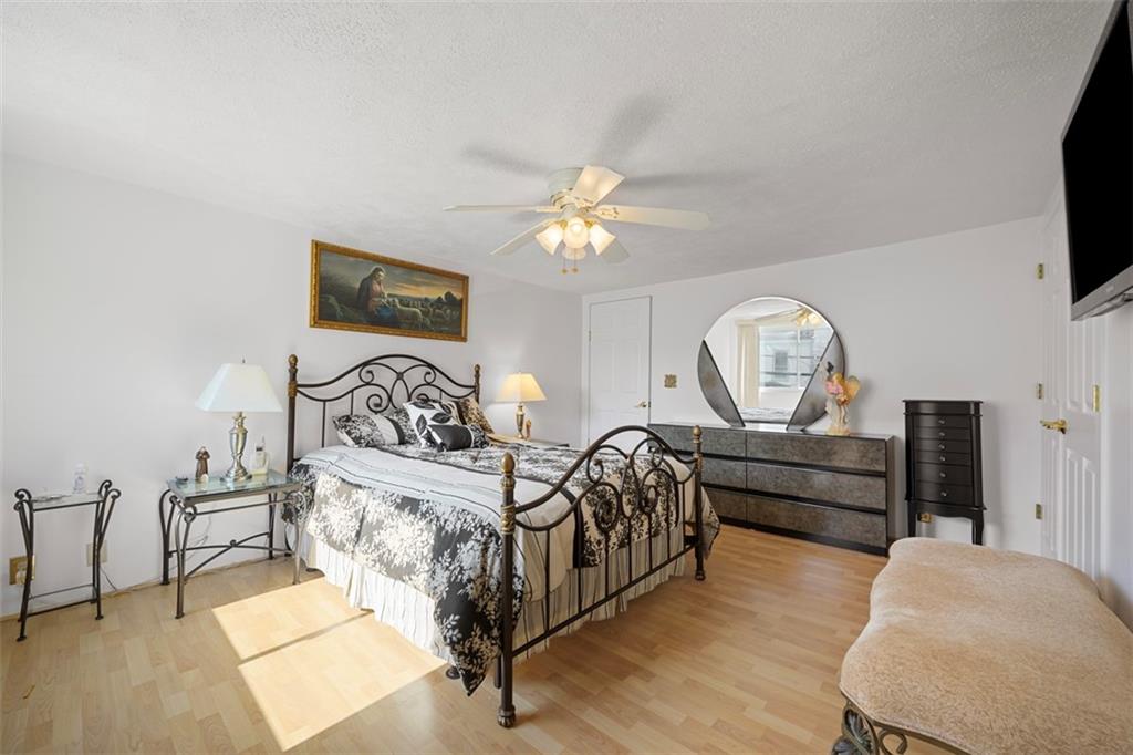 213 18th Street Pittsburgh, PA 15215 - Photo 20 of 42 a bedroom with furniture and a flat screen tv