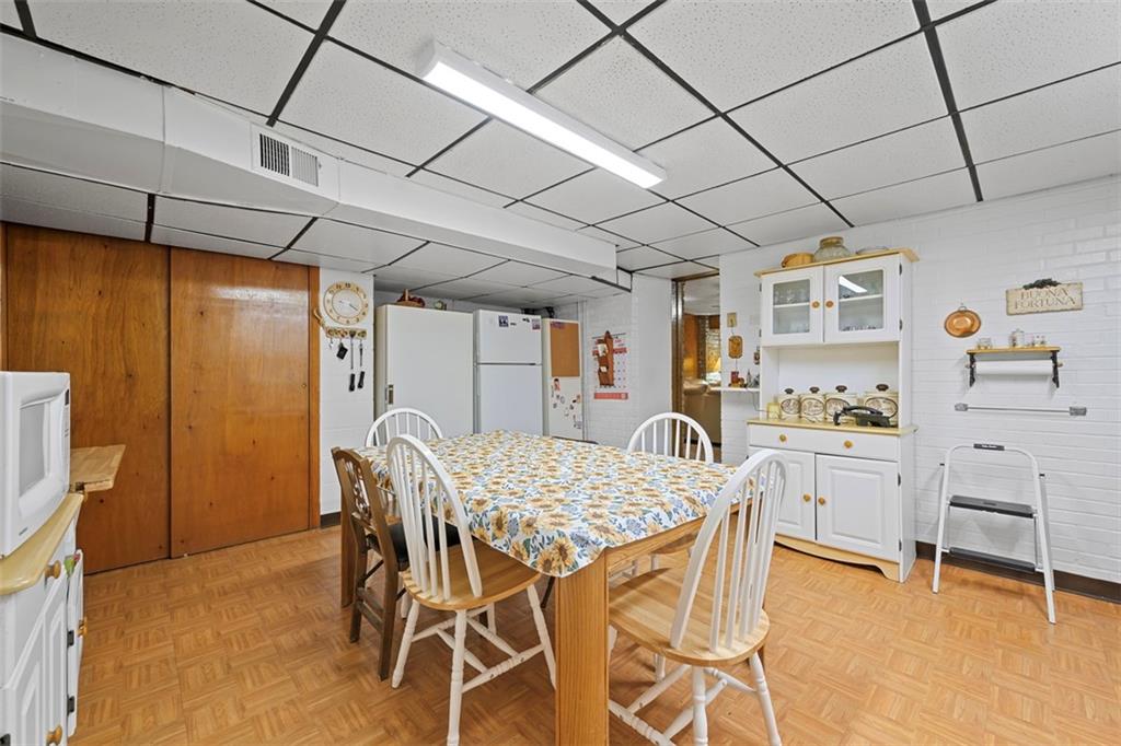 213 18th Street Pittsburgh, PA 15215 - Photo 31 of 42 a dining room with stainless steel appliances granite countertop furniture and a refrigerator