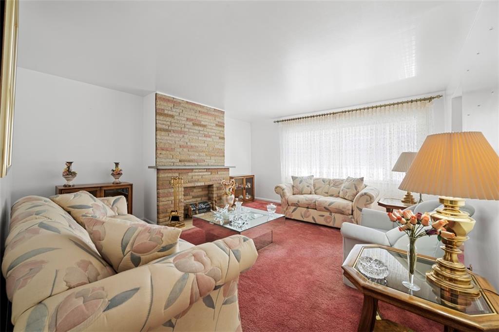 213 18th Street Pittsburgh, PA 15215 - Photo 6 of 42 a living room with furniture a fireplace and a flat screen tv