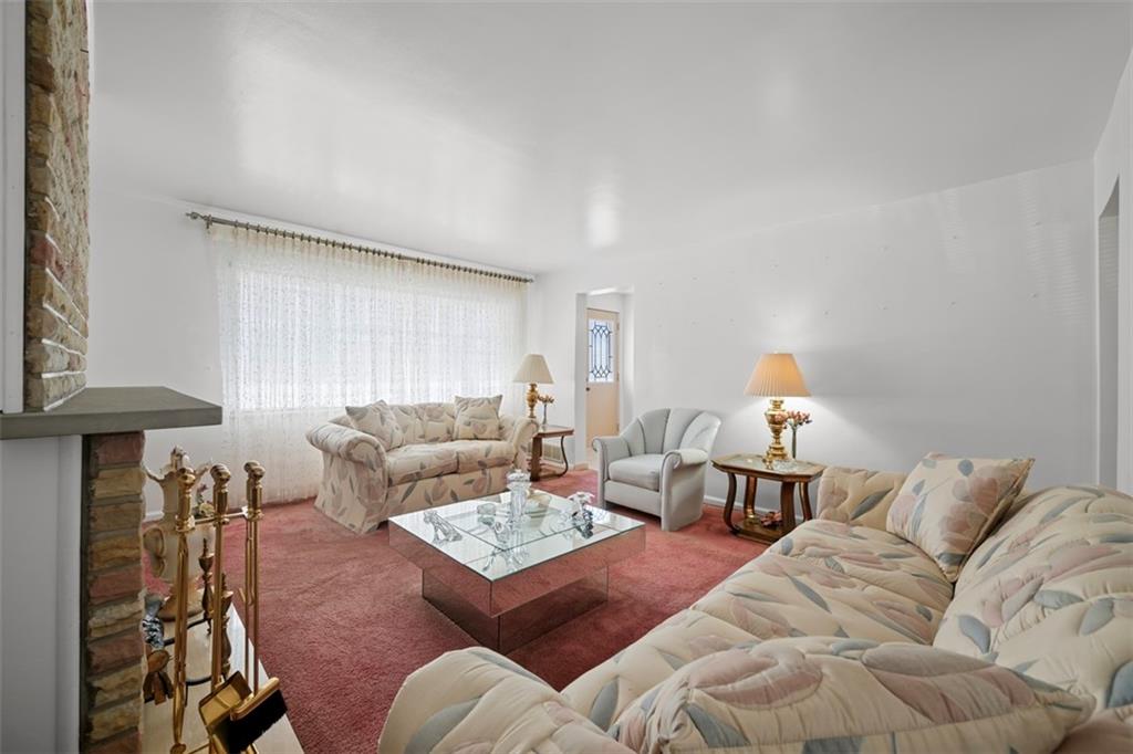 213 18th Street Pittsburgh, PA 15215 - Photo 7 of 42 a living room with furniture a lamp and a window