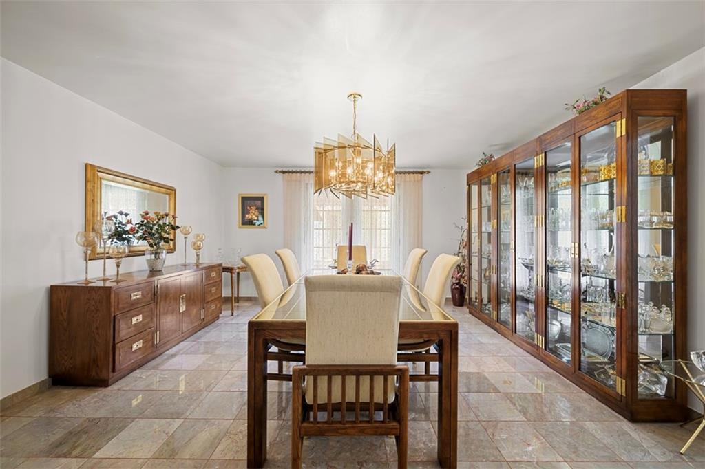 213 18th Street Pittsburgh, PA 15215 - Photo 9 of 42 a dining room with furniture a chandelier and wooden floor