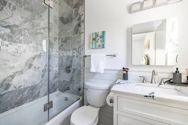 a bathroom with a sink toilet and shower
