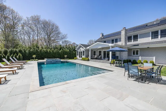 a view of a house with pool table and chairs