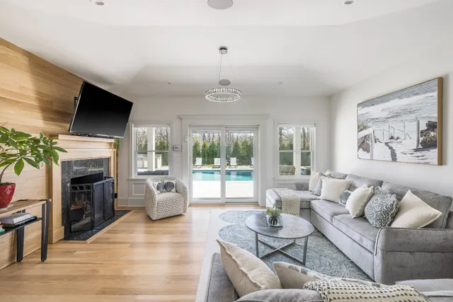 a living room with furniture a fireplace and a flat screen tv