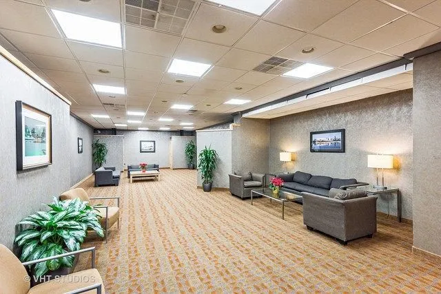 a lobby with furniture and a potted plant