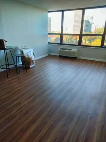 a view of room with window and wooden floor