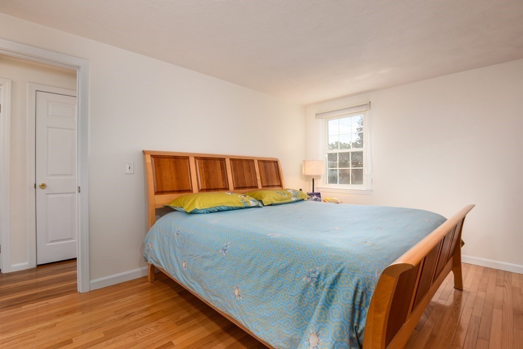 101 Standish Road Needham, MA 02492 - Photo 16 of 38 a bedroom with a bed and wooden floor
