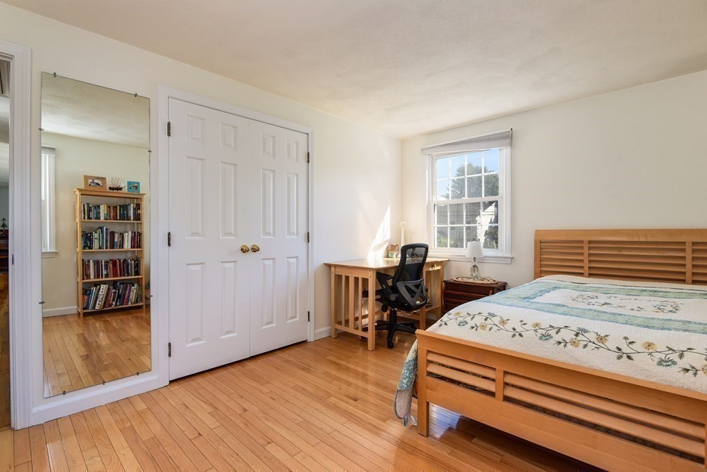 101 Standish Road Needham, MA 02492 - Photo 19 of 38 a bedroom with a bed and a table in it