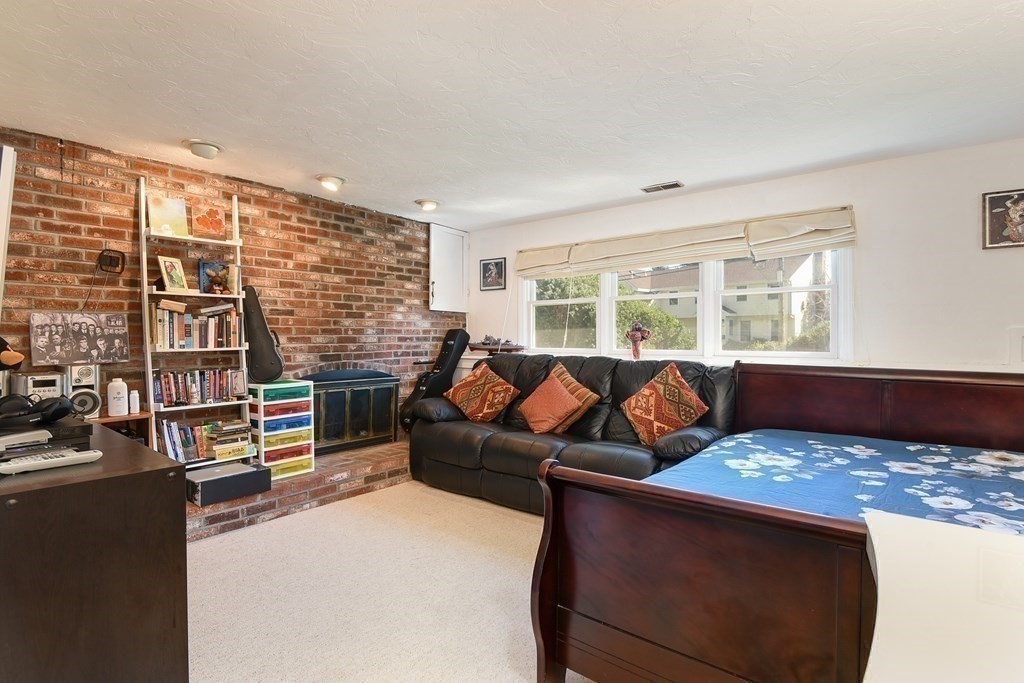 101 Standish Road Needham, MA 02492 - Photo 21 of 38 a living room with fireplace furniture and a large window