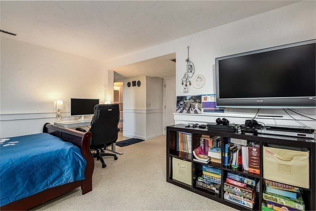 101 Standish Road Needham, MA 02492 - Photo 23 of 38 a bedroom with a bed and a flat screen tv