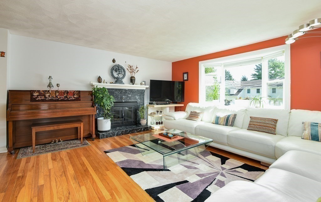 101 Standish Road Needham, MA 02492 - Photo 3 of 38 a living room with furniture a fireplace and a flat screen tv