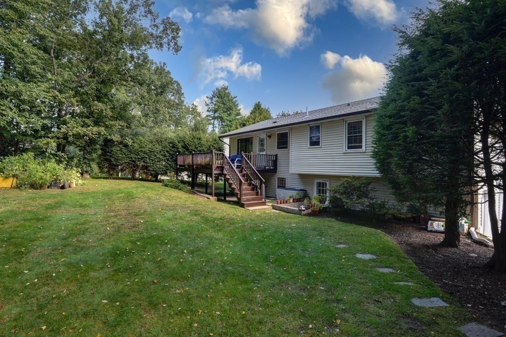 101 Standish Road Needham, MA 02492 - Photo 33 of 38 a view of a patio with table and chairs under an umbrella
