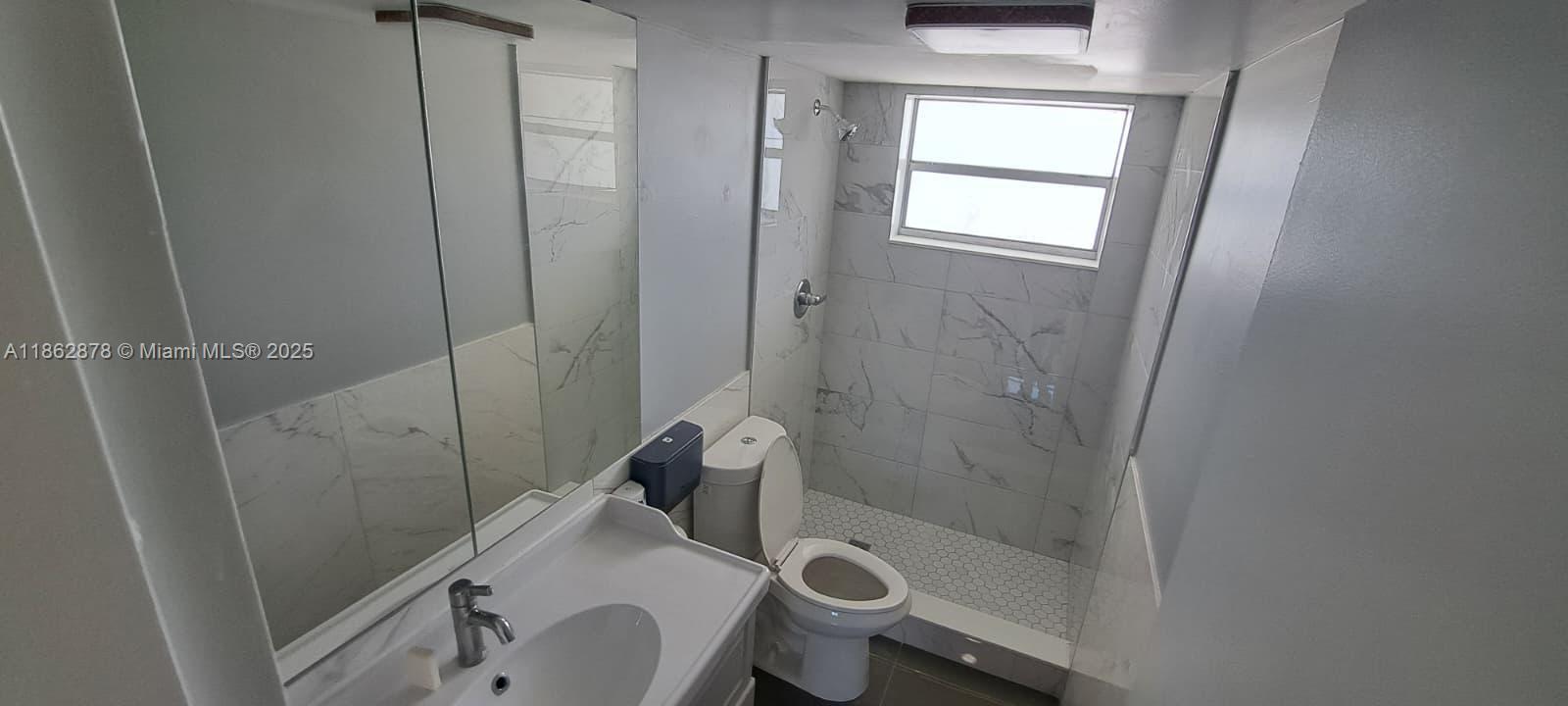14180 Southwest 84th Street, Unit 203G Miami, FL 33183 - Photo 12 of 17 a bathroom with a sink and shower