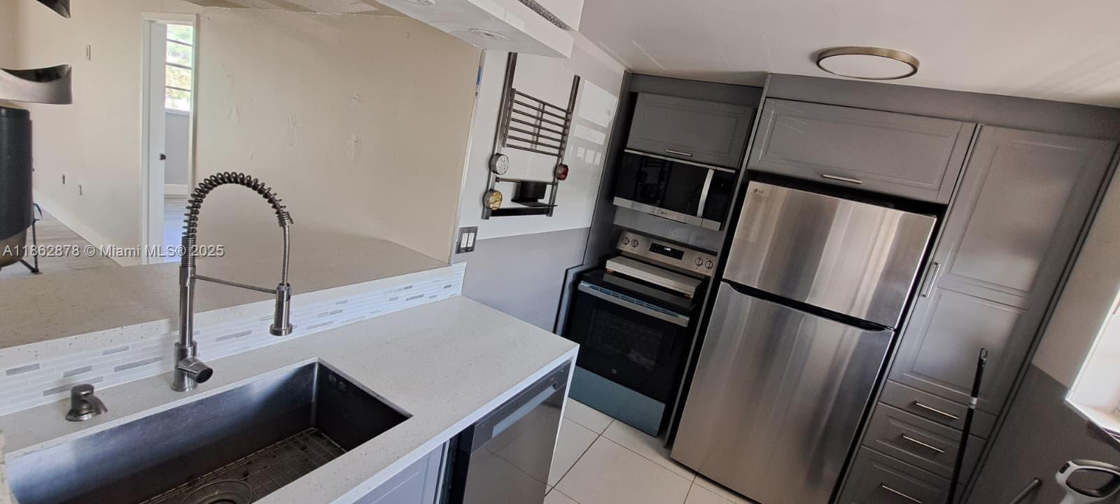 14180 Southwest 84th Street, Unit 203G Miami, FL 33183 - Photo 4 of 17 a view of a kitchen from a sink
