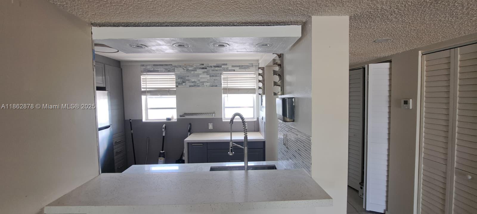 14180 Southwest 84th Street, Unit 203G Miami, FL 33183 - Photo 5 of 17 a view of spacious bedroom with a large window and chandelier