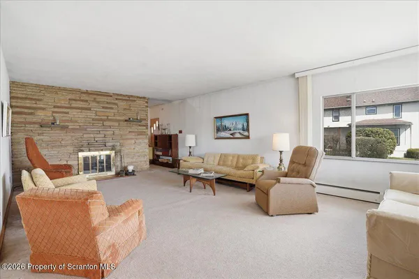 a living room with furniture and a chair