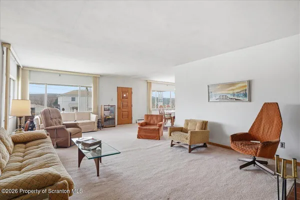 a living room with a couch and a lamp on table