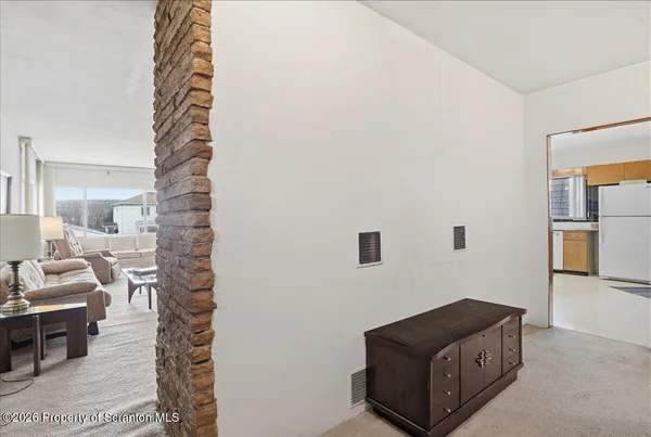 a bedroom with a bed and a mirror