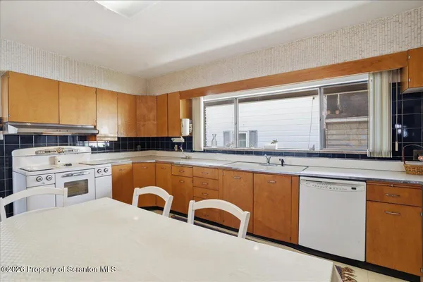 a kitchen with stainless steel appliances granite countertop a sink and cabinets