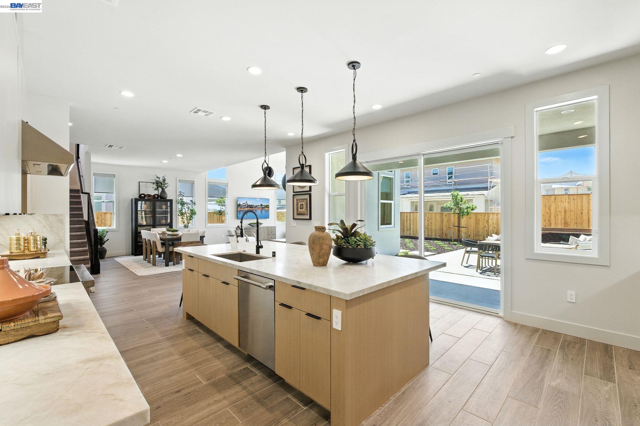 4237 Langley Road Dublin, CA 94568 - Photo 1 of 40 a open kitchen with stainless steel appliances kitchen island a large counter top a sink a stove and a wooden floors