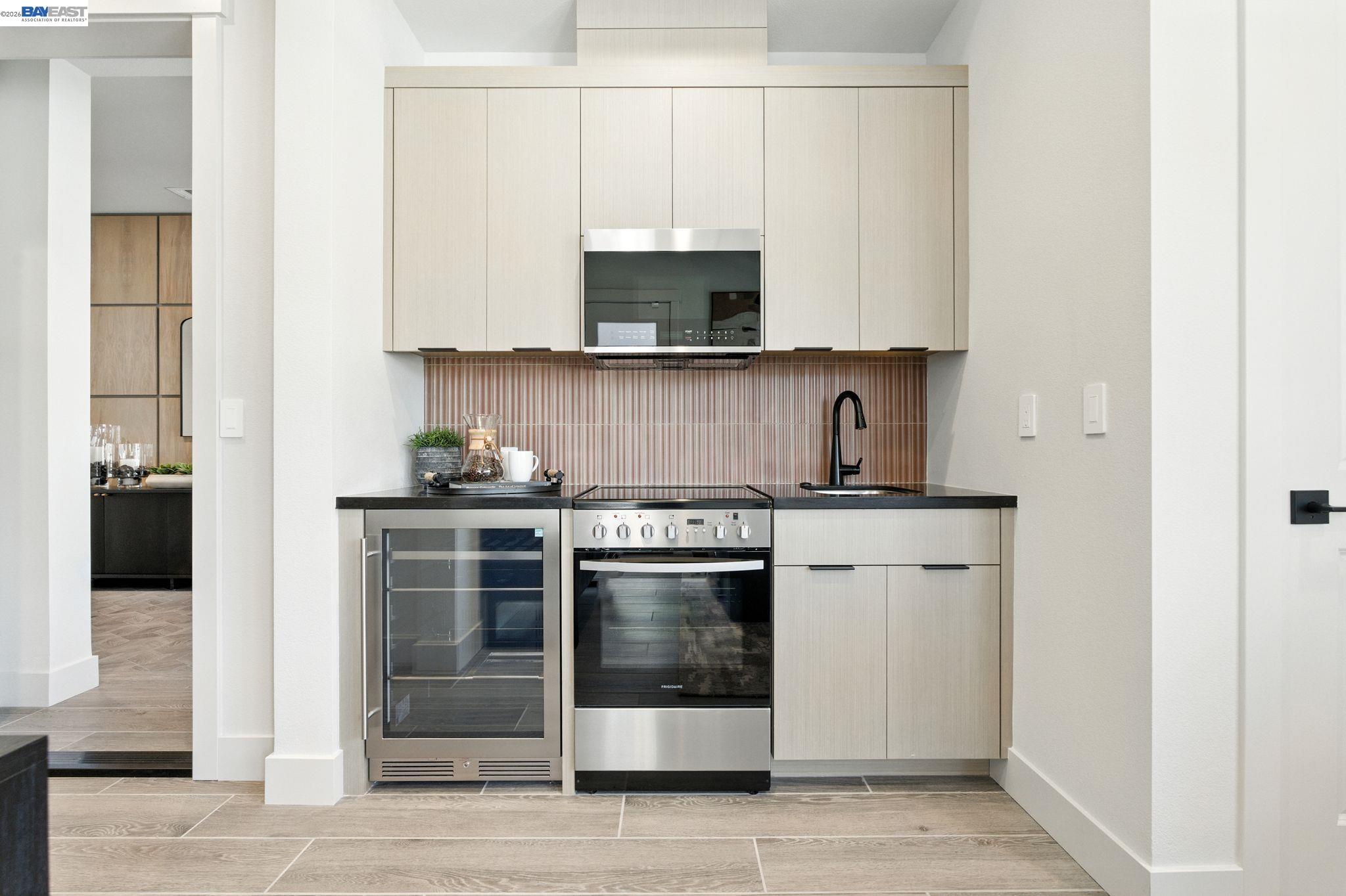 4237 Langley Road Dublin, CA 94568 - Photo 14 of 40 a kitchen with stainless steel appliances granite countertop a stove and a microwave