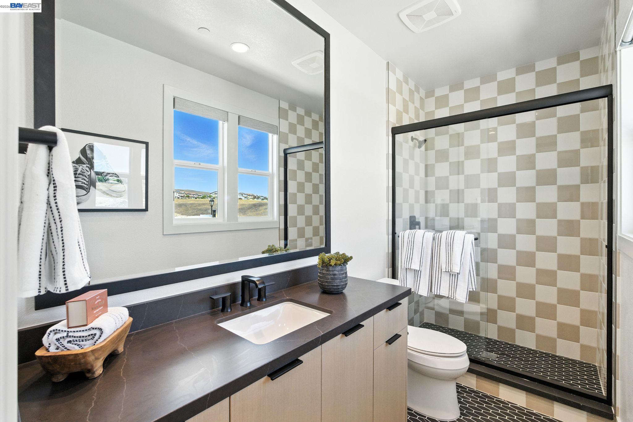 4237 Langley Road Dublin, CA 94568 - Photo 26 of 40 a bathroom with a double vanity sink toilet and a mirror