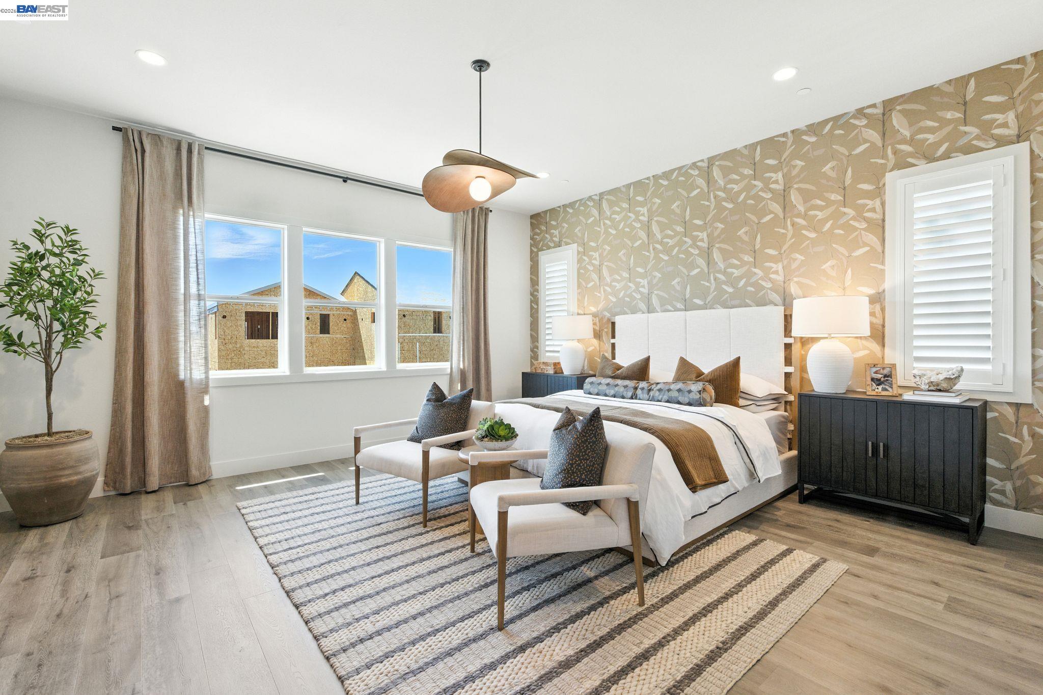 4237 Langley Road Dublin, CA 94568 - Photo 30 of 40 a spacious bedroom with a bed and wooden floor