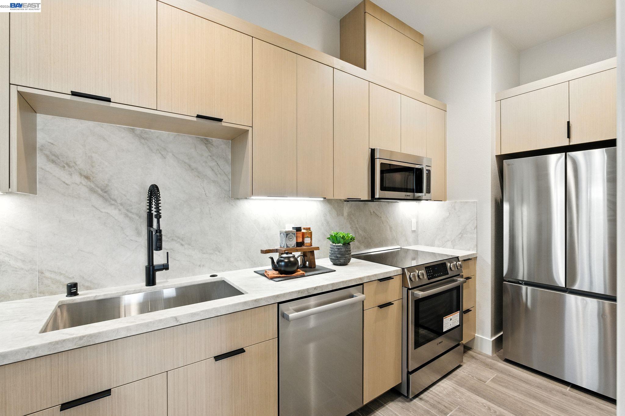 4237 Langley Road Dublin, CA 94568 - Photo 9 of 40 a kitchen with white cabinets and stainless steel appliances