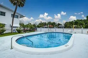 a view of a swimming pool with a yard