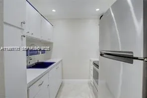 a kitchen with a refrigerator and a stove