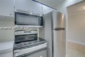 a view of a refrigerator in kitchen