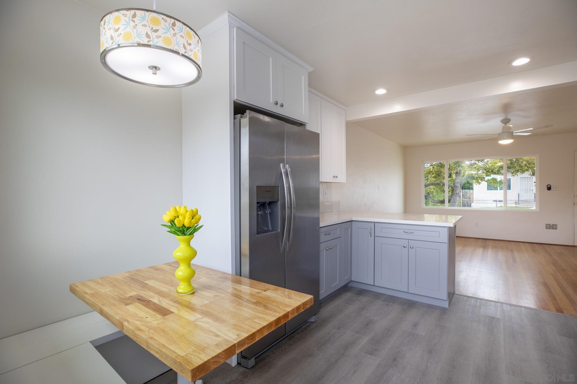 6979 Tower Street La Mesa, CA 91942 - Photo 11 of 30 a kitchen with stainless steel appliances granite countertop a granite counter tops and wooden floors