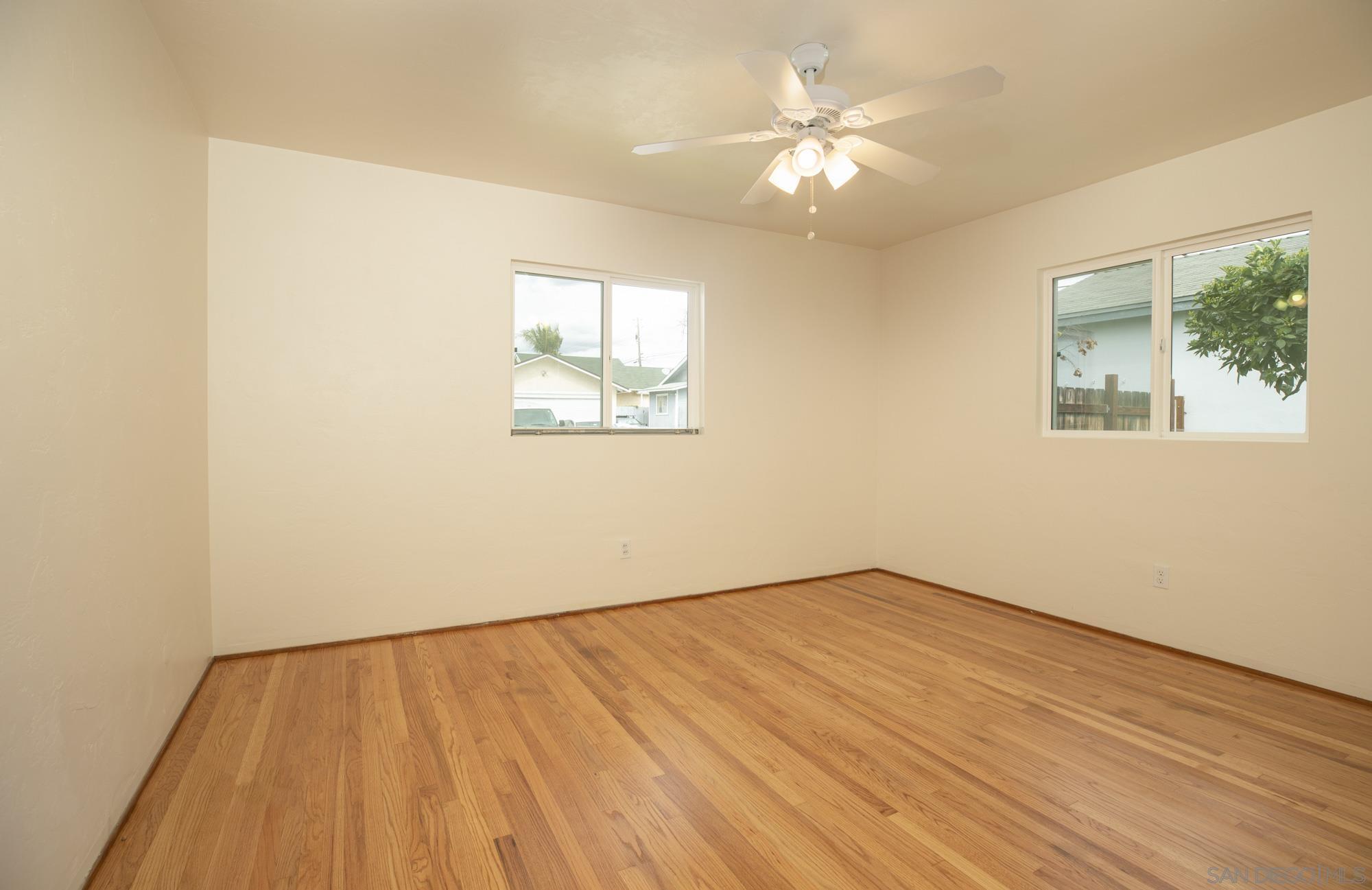6979 Tower Street La Mesa, CA 91942 - Photo 12 of 30 a view of an empty room with wooden floor and a window