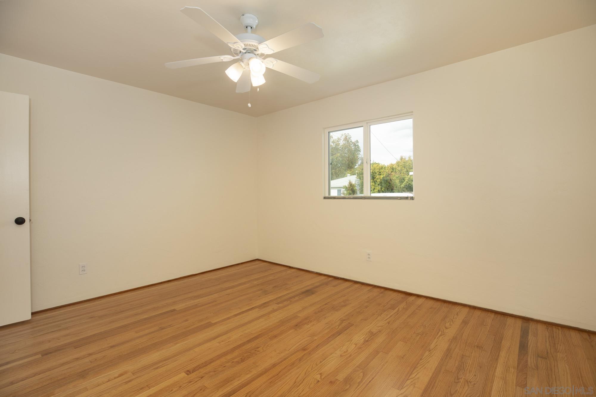 6979 Tower Street La Mesa, CA 91942 - Photo 13 of 30 an empty room with wooden floor and windows