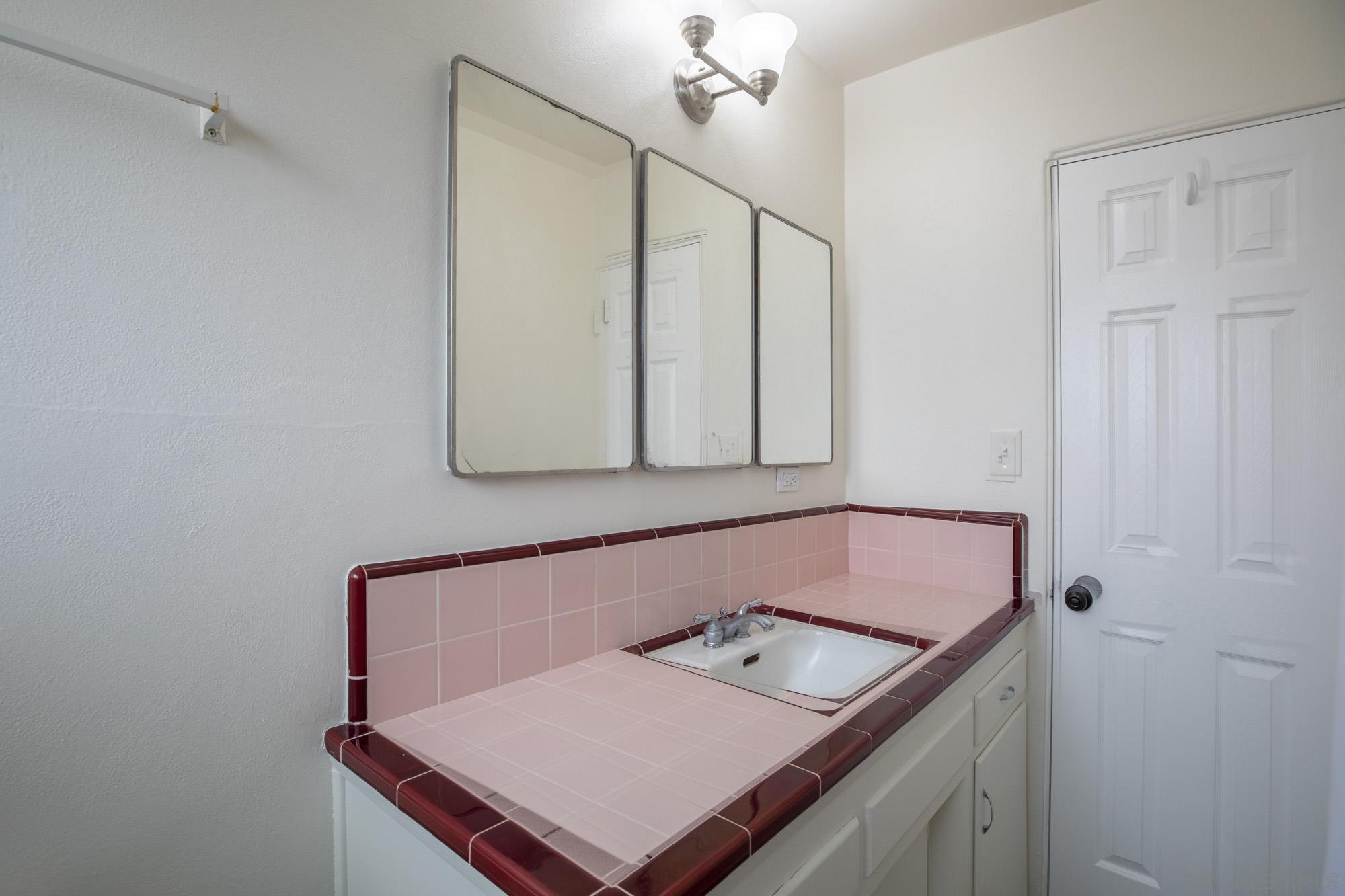 6979 Tower Street La Mesa, CA 91942 - Photo 17 of 30 a bathroom with a sink vanity and a mirror