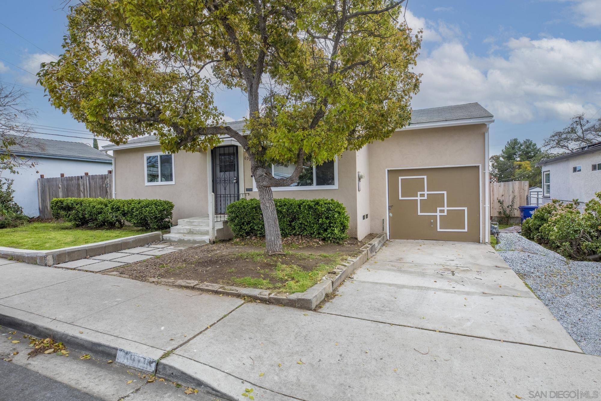 6979 Tower Street La Mesa, CA 91942 - Photo 2 of 30 a front view of a house with a yard and trees