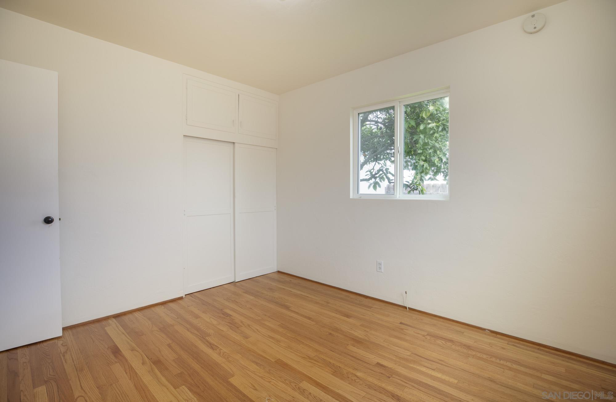 6979 Tower Street La Mesa, CA 91942 - Photo 21 of 30 an empty room with wooden floor and windows