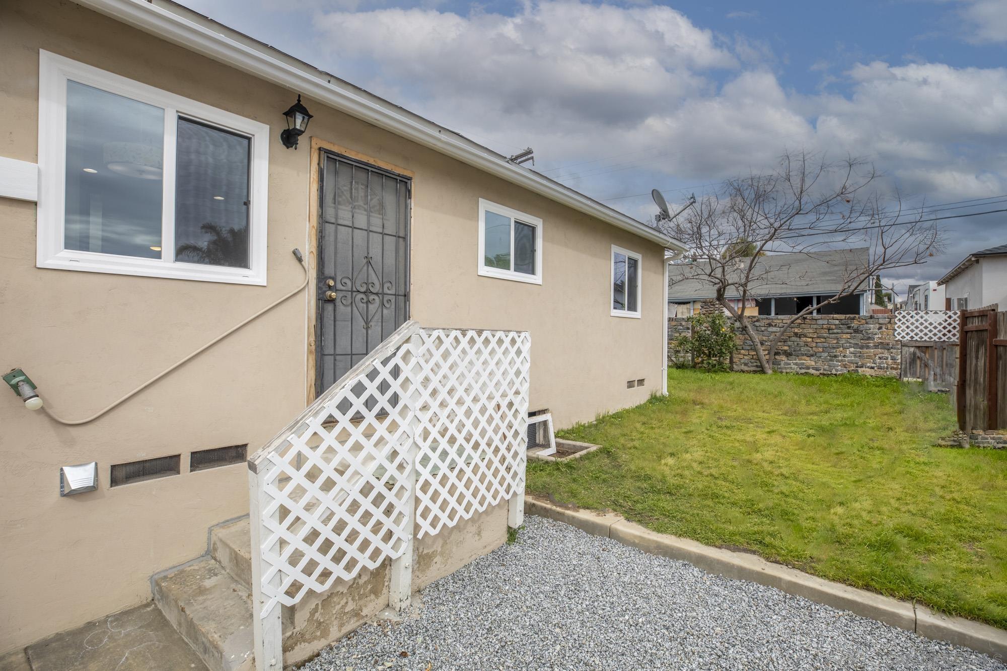 6979 Tower Street La Mesa, CA 91942 - Photo 24 of 30 a backyard of a house with a garden and barbeque oven