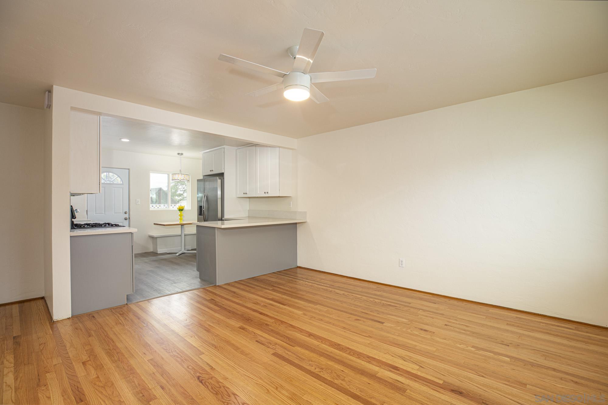 6979 Tower Street La Mesa, CA 91942 - Photo 4 of 30 a kitchen with a wooden floor and window