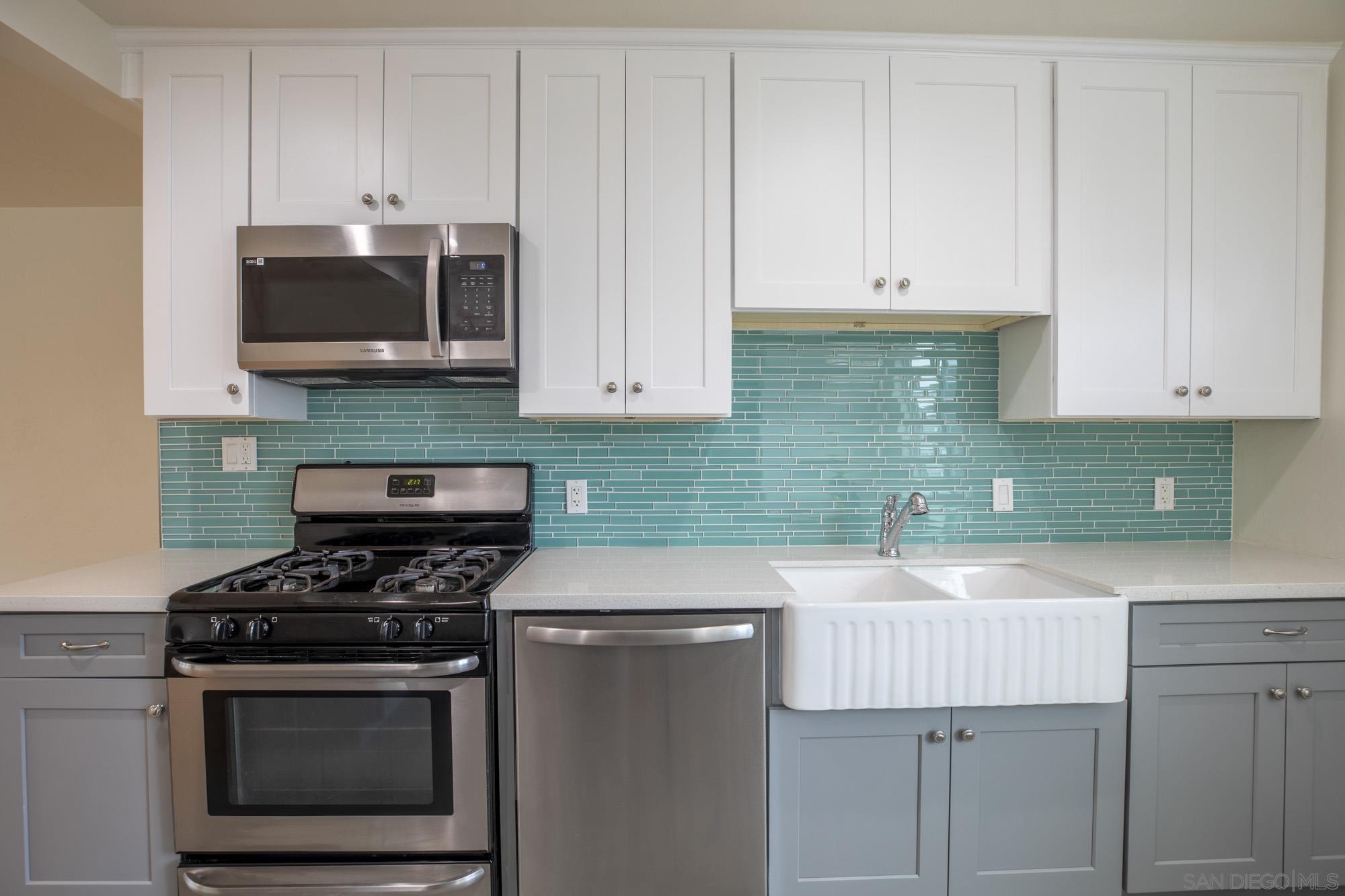 6979 Tower Street La Mesa, CA 91942 - Photo 8 of 30 a kitchen with stainless steel appliances a stove a microwave and sink