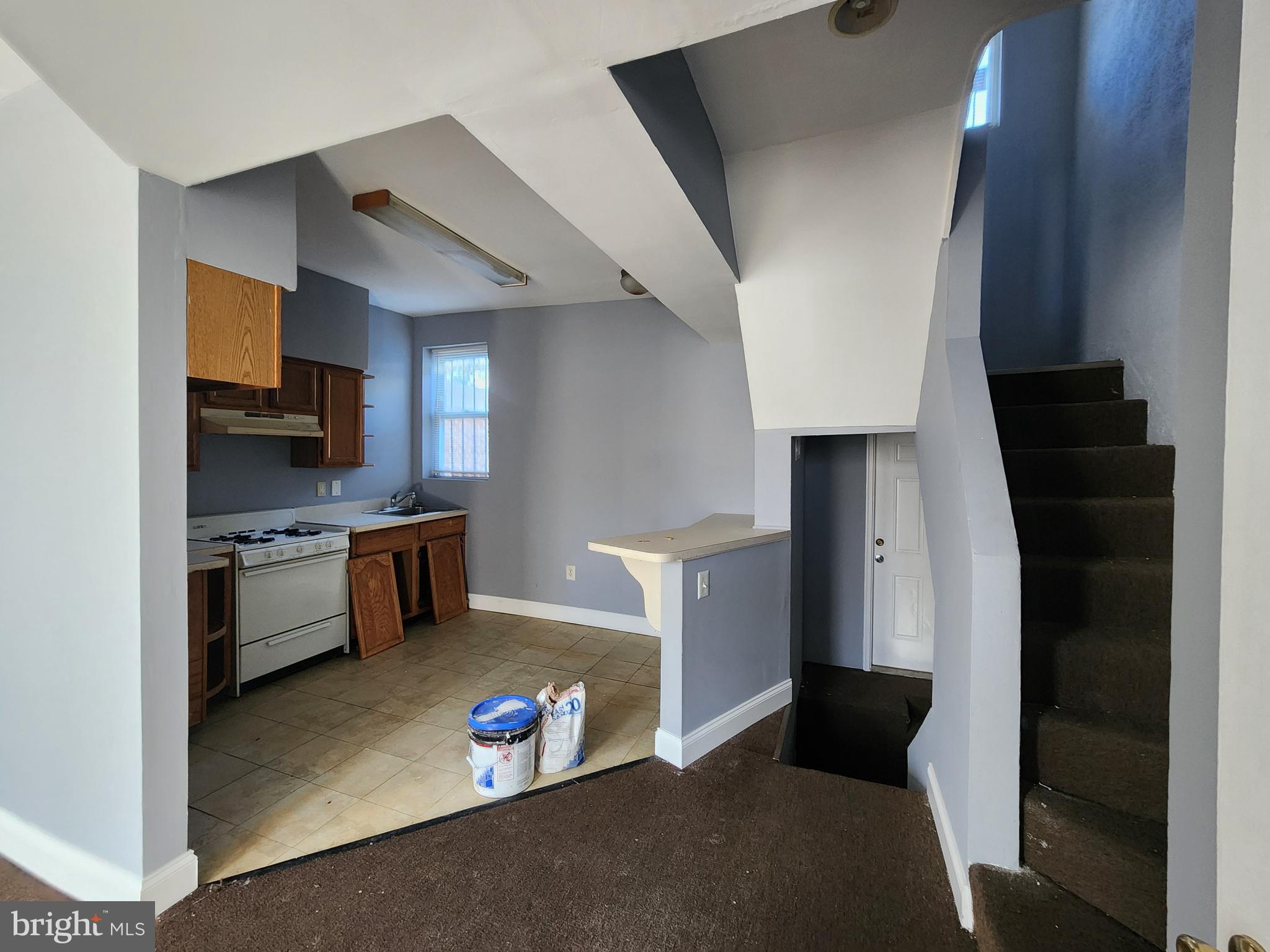 32 South Fulton Avenue Baltimore, MD 21223 - Photo 17 of 29 a kitchen with stainless steel appliances a refrigerator and a stove