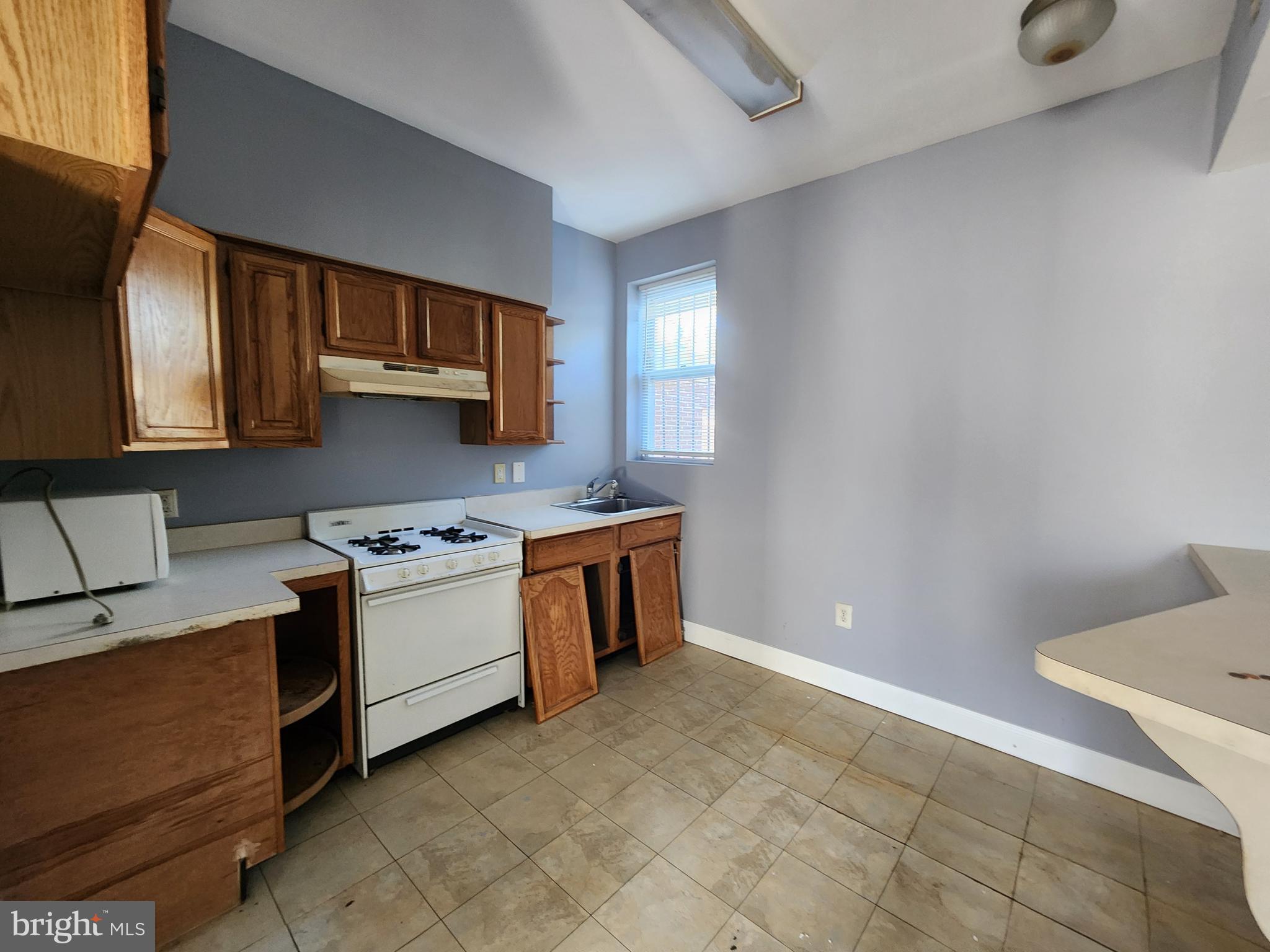 32 South Fulton Avenue Baltimore, MD 21223 - Photo 18 of 29 a kitchen with a stove and a sink