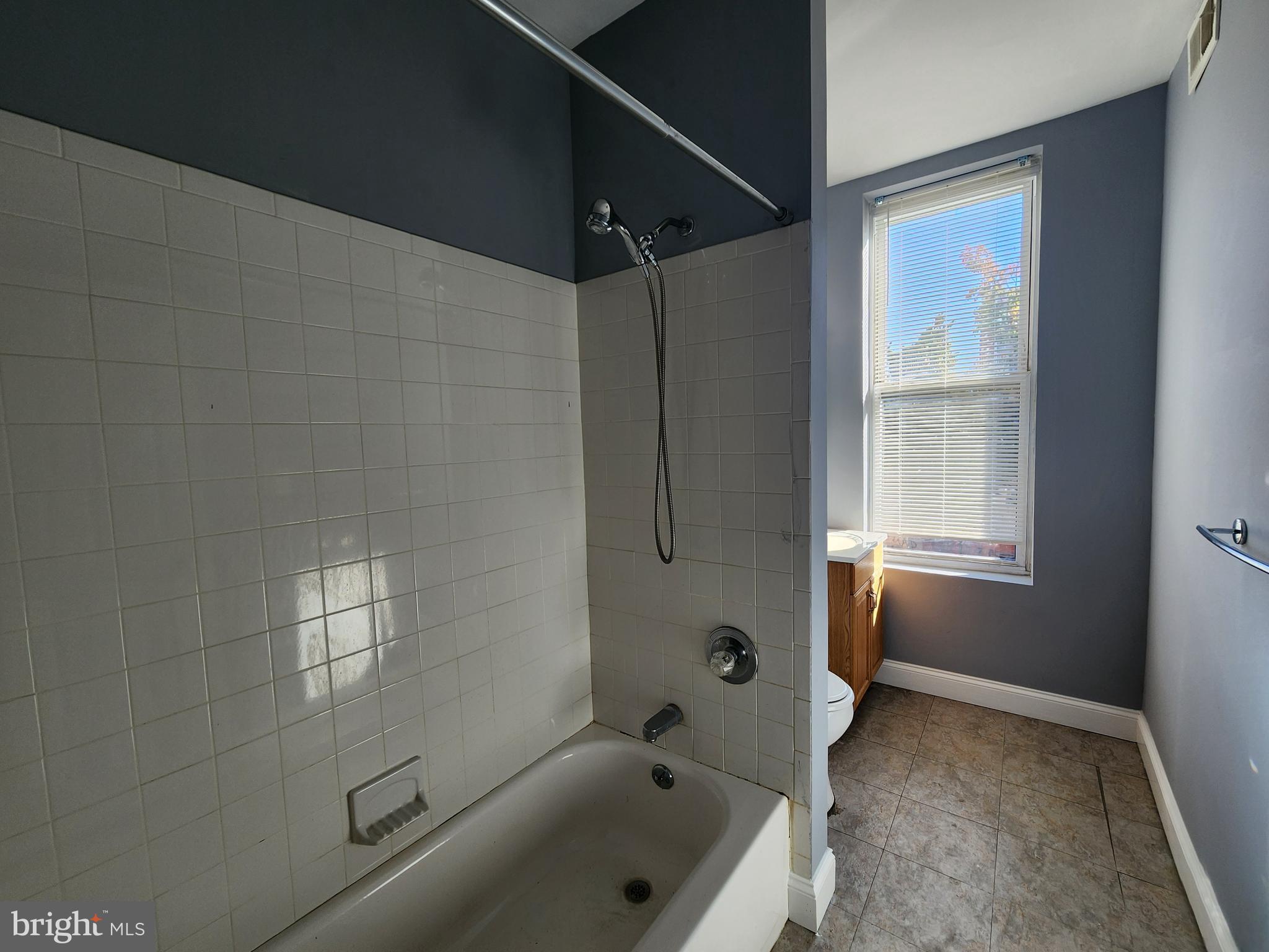 32 South Fulton Avenue Baltimore, MD 21223 - Photo 21 of 29 a bathroom with a tub a window and a shower