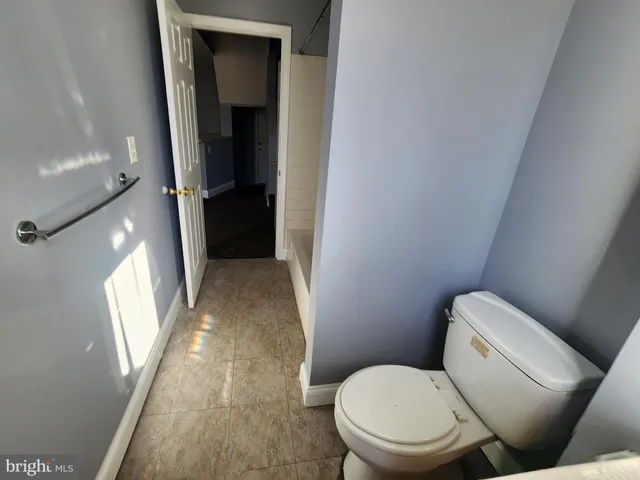 a white toilet sitting next to a window